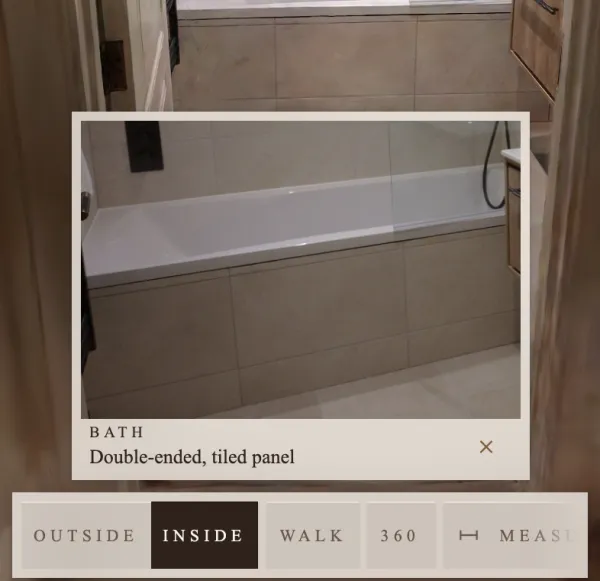 A finish opened in the viewer on a phone: a close-up photo of a bath, double-ended with a tiled panel