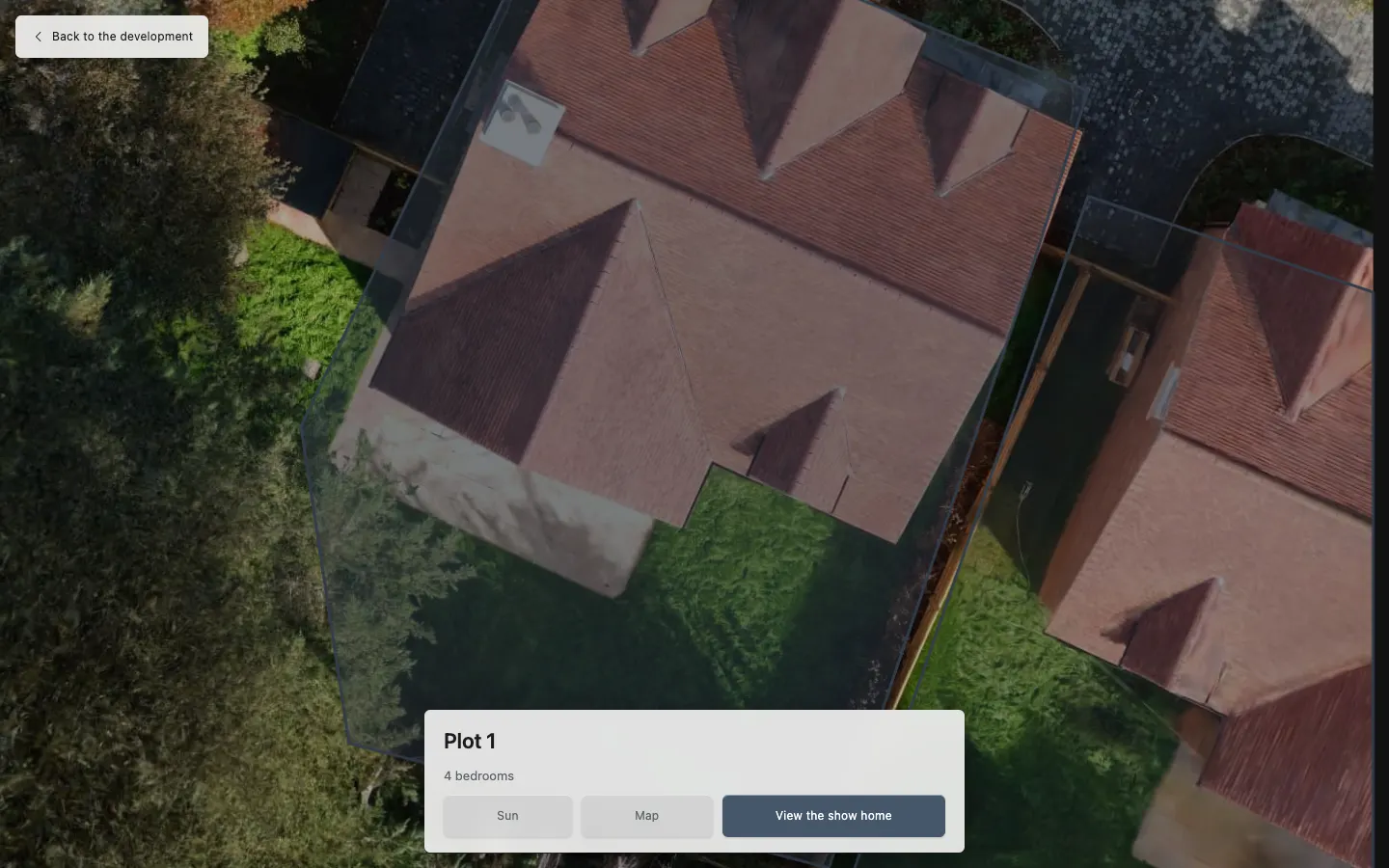 A development plan drawn over Heathcote's aerial view: a plot outlined with a card offering its sun, its map and the show home